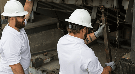 two technicians working on a dock leveler